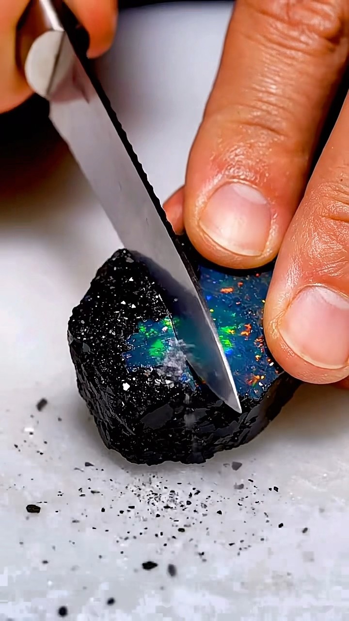 AI-generated ASMR video frame: Black opal with chromatic flames