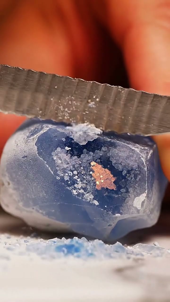 AI-generated ASMR video frame: Blue quartz, serrated knife