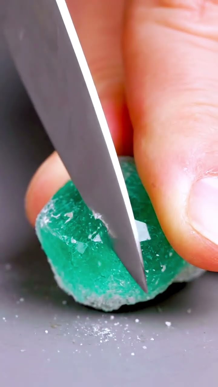 AI-generated ASMR video frame: Emerald crystal, chef’s knife on a matte counter